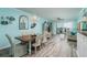 Open concept living space featuring a dining area, living room, and balcony with water views at 7932 Sailboat Key S Blvd # 506, South Pasadena, FL 33707