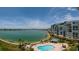 Condo complex featuring a pool with waterfront views at 7932 Sailboat Key S Blvd # 506, South Pasadena, FL 33707