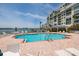 Outdoor condo pool with chairs and ocean views at 7932 Sailboat Key S Blvd # 506, South Pasadena, FL 33707