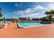 Community swimming pool and patio surrounded by lounge seating and views at 7932 Sailboat Key S Blvd # 506, South Pasadena, FL 33707