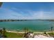 Wide water view of shoreline and city from above, featuring green spaces in the foreground at 7932 Sailboat Key S Blvd # 506, South Pasadena, FL 33707