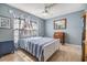 Cozy bedroom features a white bed frame, ceiling fan, and wooden desk area at 8220 12Th N Way # G, St Petersburg, FL 33702