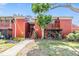 Exterior of a 2-story condo with mature trees and lush landscaping at 8220 12Th N Way # G, St Petersburg, FL 33702