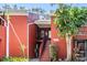 Red brick condo building featuring an outdoor staircase and balcony at 8220 12Th N Way # G, St Petersburg, FL 33702
