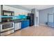 Kitchen with stainless steel appliances and light, laminate flooring at 8220 12Th N Way # G, St Petersburg, FL 33702