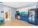 Kitchen with stainless steel appliances, and blue and white cabinetry at 8220 12Th N Way # G, St Petersburg, FL 33702