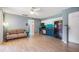 Open living area with stainless steel appliances and laminate flooring at 8220 12Th N Way # G, St Petersburg, FL 33702
