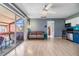 Living room with fan, sliding glass door leading to the patio, and stainless steel appliances at 8220 12Th N Way # G, St Petersburg, FL 33702