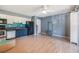 Open living area featuring light wood floors with kitchen and white storage cabinet at 8220 12Th N Way # G, St Petersburg, FL 33702