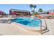 Community swimming pool with a white fence and lounge chairs at 8220 12Th N Way # G, St Petersburg, FL 33702