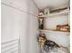 Shelved storage area containing paint cans, boxes, and a vacuum hose at 8220 12Th N Way # G, St Petersburg, FL 33702