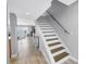Open-concept living room featuring tile flooring, stairway and picturesque ocean views at 8226 W Gulf Blvd # 2, Treasure Island, FL 33706