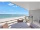 Relaxing patio area with a dining set, offering scenic beach views at 8226 W Gulf Blvd # 2, Treasure Island, FL 33706