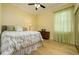 Inviting bedroom with wood-look floors and a patterned bedspread beneath a ceiling fan at 8444 Shenandoah Run, Wesley Chapel, FL 33544