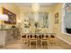 Elegant dining room with a modern chandelier, stylish furniture, and large mirror at 8444 Shenandoah Run, Wesley Chapel, FL 33544