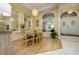 Elegant dining room featuring a glass table, chandelier lighting, and large arched windows at 8444 Shenandoah Run, Wesley Chapel, FL 33544