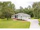 Charming single story home with lush lawn, mature trees, and long driveway for ample parking at 8444 Shenandoah Run, Wesley Chapel, FL 33544