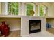 Elegant fireplace with a marble surround, complemented by decorative vases and natural light at 8444 Shenandoah Run, Wesley Chapel, FL 33544