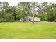 Spacious front yard with lush lawn and mature trees enhancing curb appeal at 8444 Shenandoah Run, Wesley Chapel, FL 33544