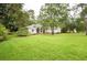 Inviting front yard with well-manicured lawn and mature trees at 8444 Shenandoah Run, Wesley Chapel, FL 33544