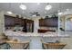 Spacious kitchen with dark wood cabinets, granite countertops, and a breakfast bar at 8444 Shenandoah Run, Wesley Chapel, FL 33544