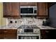 Modern kitchen featuring stainless steel appliances and granite countertops at 8444 Shenandoah Run, Wesley Chapel, FL 33544