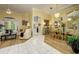 Open concept living and dining area featuring a crystal chandelier and neutral decor at 8444 Shenandoah Run, Wesley Chapel, FL 33544
