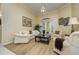Cozy living room with comfortable seating, a ceiling fan, and views to the outdoor patio at 8444 Shenandoah Run, Wesley Chapel, FL 33544