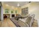 Cozy living room with fireplace, beautiful windows, and neutral color scheme at 8444 Shenandoah Run, Wesley Chapel, FL 33544