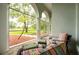 Relaxing screened patio offering views of the lawn and surrounding greenery at 8444 Shenandoah Run, Wesley Chapel, FL 33544
