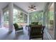 Relaxing screened porch with comfortable seating and views of the lush backyard at 8444 Shenandoah Run, Wesley Chapel, FL 33544