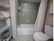 Clean bathroom with a shower over tub, featuring tiled walls, and essential fixtures at 8765 Bardmoor Blvd # 108, Seminole, FL 33777