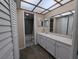 Bright bathroom featuring a vanity, and tile accents, creating a clean and functional space at 8765 Bardmoor Blvd # 108, Seminole, FL 33777