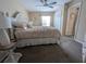 Comfortable bedroom with a ceiling fan, plush carpet, and window, offering a serene space at 8765 Bardmoor Blvd # 108, Seminole, FL 33777