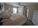 Comfortable bedroom with a ceiling fan, plush carpet, and window, offering a serene space at 8765 Bardmoor Blvd # 108, Seminole, FL 33777