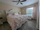 Comfortable bedroom with ceiling fan, plush carpet, and a window letting in natural light at 8765 Bardmoor Blvd # 108, Seminole, FL 33777