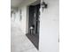 Cozy condo entryway featuring textured walls and updated lighting fixture at 8765 Bardmoor Blvd # 108, Seminole, FL 33777