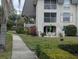 Building exterior showcasing a charming patio area accessible from the ground floor at 8765 Bardmoor Blvd # 108, Seminole, FL 33777