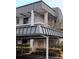 Multi-level condo building featuring a covered parking area and balcony at 8765 Bardmoor Blvd # 108, Seminole, FL 33777