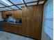 Spacious kitchen featuring wood cabinetry, stone countertops, and modern appliances at 8765 Bardmoor Blvd # 108, Seminole, FL 33777