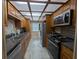 Galley kitchen with wood cabinets, stainless steel appliances, and plenty of counter space at 8765 Bardmoor Blvd # 108, Seminole, FL 33777
