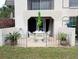 Comfortable patio featuring a round table, four chairs, and garden views at 8765 Bardmoor Blvd # 108, Seminole, FL 33777