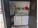 Outdoor closet featuring stacked washer and dryer, plus overhead storage for convenience at 8765 Bardmoor Blvd # 108, Seminole, FL 33777