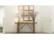 Inviting entryway with a decorative mirror, wooden console table with lamp, and a vase of flowers against a neutral wall at 8786 Linked Dr, New Port Richey, FL 34655