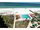 Expansive aerial shot of a luxurious resort featuring a large pool, beautiful beach, and scenic waterfront at 880 Mandalay Ave # C1103, Clearwater Beach, FL 33767