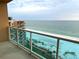 A balcony overlooking the beach, with a glass railing for unobstructed ocean views at 880 Mandalay Ave # C1103, Clearwater Beach, FL 33767