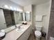 Bathroom featuring marble style tiles, toilet, single sink vanity, medicine cabinet and towel rack at 880 Mandalay Ave # C1103, Clearwater Beach, FL 33767