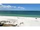 View of a white sandy beach and ocean from a high-rise balcony on a bright day at 880 Mandalay Ave # C1103, Clearwater Beach, FL 33767