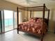 Large bedroom featuring a four-poster bed and an ocean view at 880 Mandalay Ave # C1103, Clearwater Beach, FL 33767