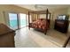 Large bedroom featuring a four-poster bed and an ocean view at 880 Mandalay Ave # C1103, Clearwater Beach, FL 33767